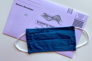 Face Mask On Top Of Election Ballot